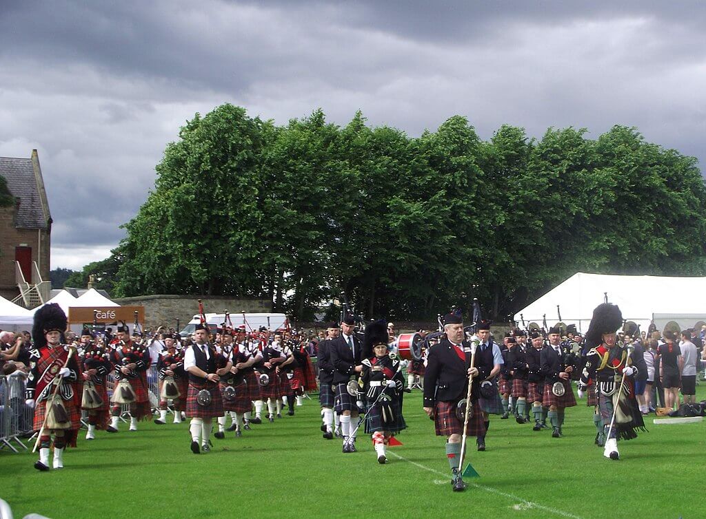 Highland games large group of scottish musicians, pipe band players